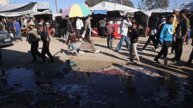 Des Palestiniens se promènent dans un camp de réfugiés.