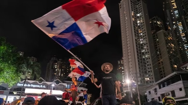 Demonstrators wave Panamanian flags during a protest against First Quantum Minerals Ltd. in Panama City, Panama, last month. Escalating protests showing no signs of abating have paralyzed the country in recent weeks. (Walter Hurtado/Bloomberg)