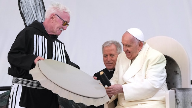 Pope Francis receives a traditional drum as a gift during a public event in Iqaluit, Nunavut on Friday, July 29, 2022, during his papal visit across Canada. THE CANADIAN PRESS/Nathan Denette