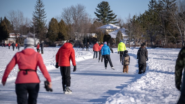 Plusieurs patineurs sur le sentier glacé du lac à la Tortue.