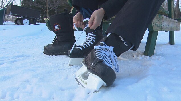 Un patineur enfile ses patins.