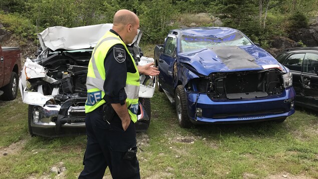 Pierre Girard devant deux camionnettes accidentées Pierre Girard devant deux camionnettes accidentées