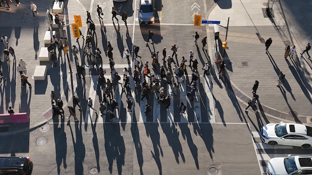 Images aériennes (drone) des piétons en fin de journée sur la rue Front, se dirigeant vers la gare Union Station.