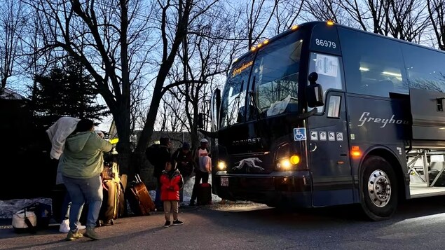 A group of migrants who were sent back to the United States after spending three days in custody on the Canada-U.S. border took a bus from Plattsburgh, N.Y., to New York City Tuesday night. (Verity Stevenson/CBC)