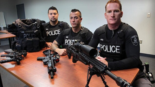 Des policiers et des fusils sur une table Des policiers et des fusils sur une table
