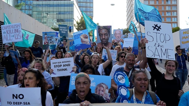 Demonstrators carry banners and flags during a protest outside the venue hosting the United Nations Ocean Conference in Lisbon, Wednesday, June 29, 2022. From June 27 to July 1, the United Nations is holding its Oceans Conference aiming to bring fresh momentum for efforts to find an international agreement on protecting the world's oceans.