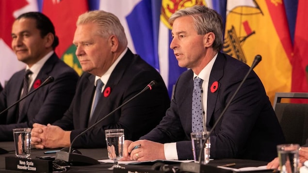 Nova Scotia Premier Tim Houston, right, speaks during a press conference at the meeting of the Council of the Federation in Halifax on Monday, Nov. 6, 2023. 