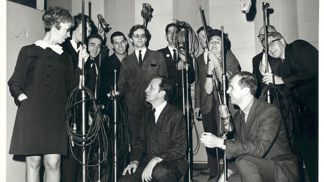 Groupe de 12 personnes rassemblées dans un studio. Groupe de 12 personnes rassemblées dans un studio.