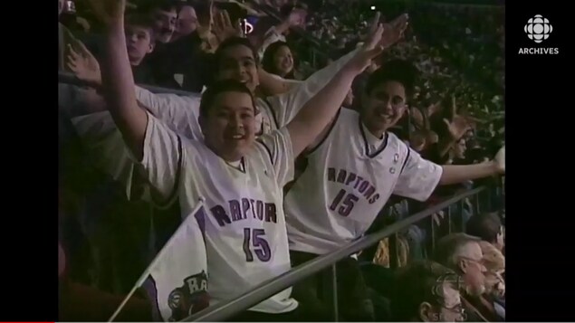 Young supporters of Raptors in the stands of the ⁣Air canada Center ‍who wear the Vince Carter sweater.