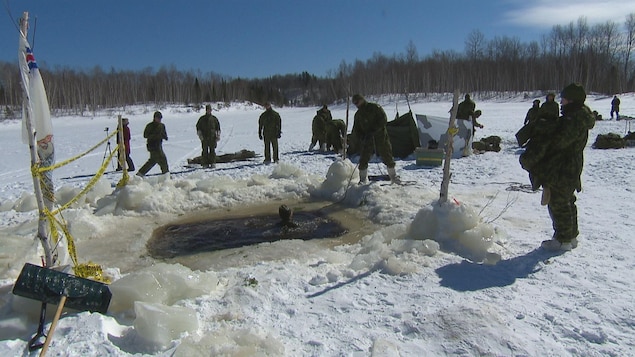 Les militaires du Régiment du Saguenay observe un de leurs collègues qui est dans l'eau. Les militaires du Régiment du Saguenay observe un de leurs collègues qui est dans l'eau.