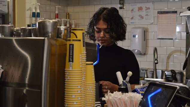 Shramana Sarkar works variable shifts at two coffee shops while fitting in time to study and teach. From week to week, she doesn't know when she'll work or how much money she'll bring home. (Malone Mullin/CBC)