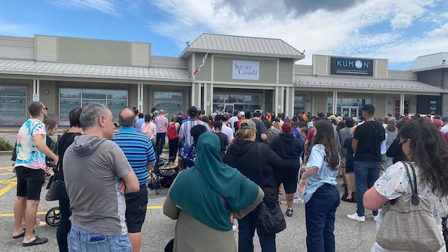 A line of close to 300 people formed before dawn outside this Service Centre in Laval, Que., on July 30.