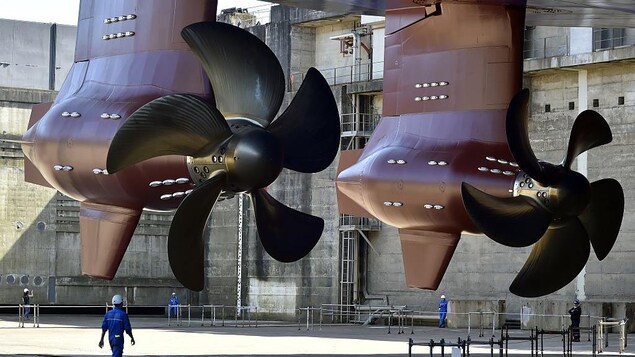 A technician looks at a propeller at the construction site of a cruise ship. 