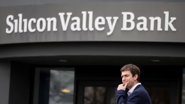 A customer stands outside of the shuttered headquarters of Silicon Valley Bank on Friday in Santa Clara, Calif. The bank was shut down by regulators on Friday. (Justin Sullivan/Getty Images)