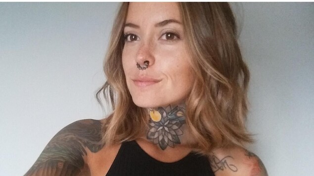 Une jeune femme tatouée avec un anneau dans le nez Une jeune femme tatouée avec un anneau dans le nez