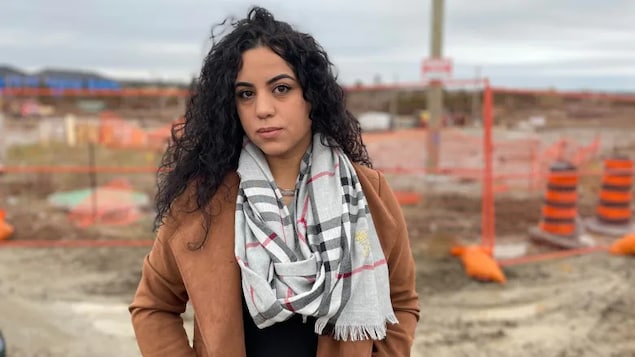 Soraya Palma is standing at the Barrie, Ont., development site for which she had paid a deposit on a condo to be finished in April 2022. 