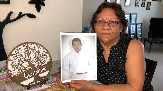 Susan Chief holds a picture of her late brother, Danny Chief, who was adopted into the United States during the Sixties Scoop. 