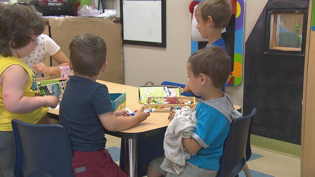 Des enfants s'amusent à une table.