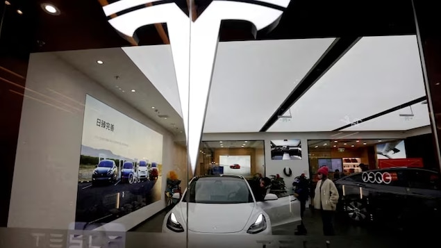 Visitors check a Tesla Model 3 car next to a Model Y on display in February 2023 in a showroom of the U.S. electric vehicle maker in Beijing. Tesla is recalling nearly all of the vehicles it has sold in the U.S. to fix a defective system that's supposed to ensure drivers are paying attention when they use Autopilot. 