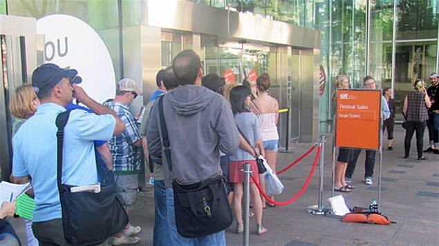 Les passionnés de cinéma font la file pour acheter des billets. Les passionnés de cinéma font la file pour acheter des billets.