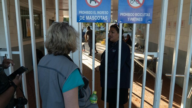 Deux femmes parlent devant un portail d'un stade de Tijuana. Deux femmes parlent devant un portail d'un stade de Tijuana.