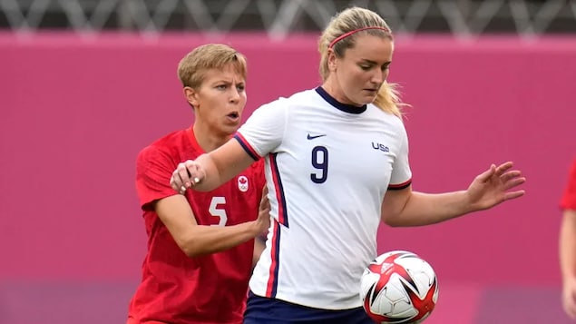 Canada's Quinn, left, and Lindsey Horan of the United States battle for the ball during their semifinal soccer match at Tokyo 2020 at Kashima Stadium on Monday.