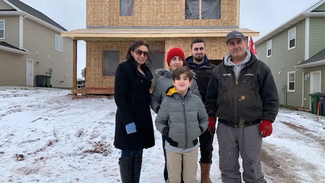 The Toma family is shown in front of their new home. From left, in the back, are Basma, Thomas, Odiss and Joseph. Peter is in front. Andre, one of four sons, is missing from the photo.