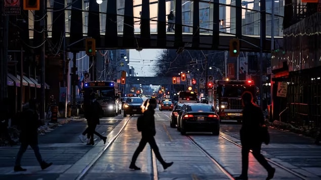 Pedestrians are shown during the evening commute in Toronto in February 2022. Hybrid immunity from vaccination and prior infection is holding up against hospitalizations and deaths and will likely continue to help control the severity of COVID in Canada and around the world for the foreseeable future. (Evan Mitsui/CBC)