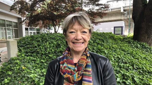 Nicole Smith MacGregor devant un buisson, dans un quartier urbain Nicole Smith MacGregor devant un buisson, dans un quartier urbain