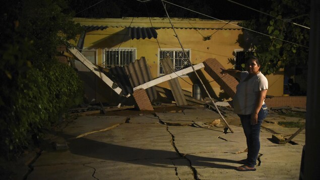Une femme montre les dommages subis par sa maison à Coatzacoalcos, dans l'État de Veracruz.