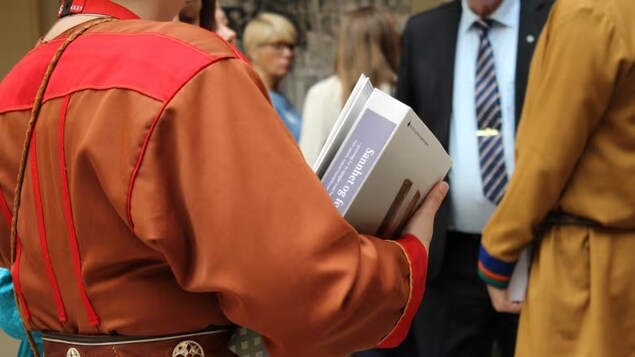 A picture of a man holding a report. 