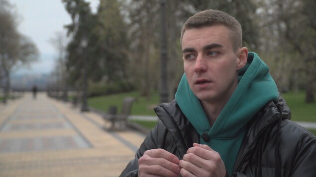 A man speaking in a park