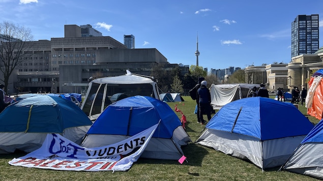 Des tentes installées sur la pelouse du cercle du King's College de l'Université de Toronto avec une affiche avec l'insciption « U of T Sudents with Palestine », le 2 mai 2024.