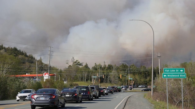 Smoke blows across a road in the Westwood Hills area outside Halifax on Monday.