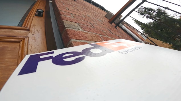 Boîte FedEx laissée sur le pas d'une porte.