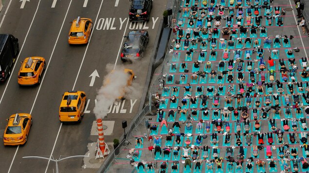 Des gens font du yoga dans Times Square à New York. Des gens font du yoga dans Times Square à New York.