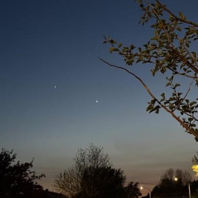 Un ciel sombre avec deux point lumineux.