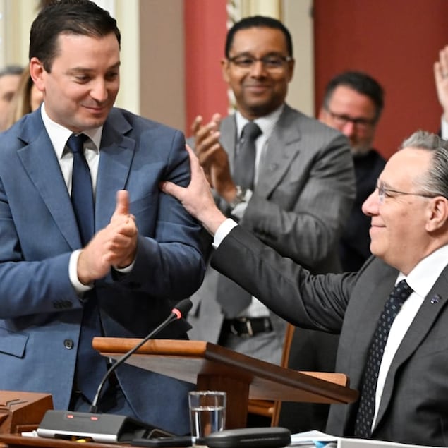 Quebec Premier François Legault, right, congratulates Quebec Justice Minister Simon Jolin-Barrette in October after he tabled legislation to create a Quebec constitution. The bill has faced criticism in the months since.