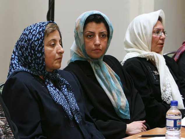 In this Aug. 27, 2007 file photo, Mohammadi, centre, sits next to 2003 Iranian Nobel Peace Prize laureate Shirin Ebadi, left, while attending a meeting on women's rights in Tehran. (Vahid Salemi/The Associated Press)