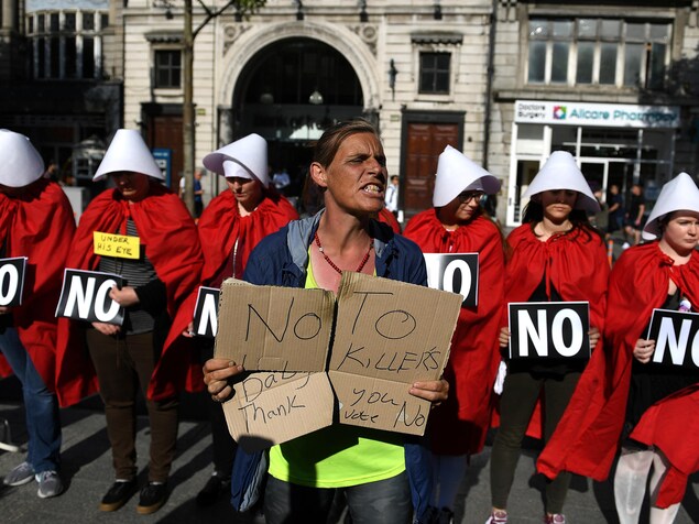 Une activiste pro-vie se place devant une manifestation pro-choix. Une activiste pro-vie se place devant une manifestation pro-choix.
