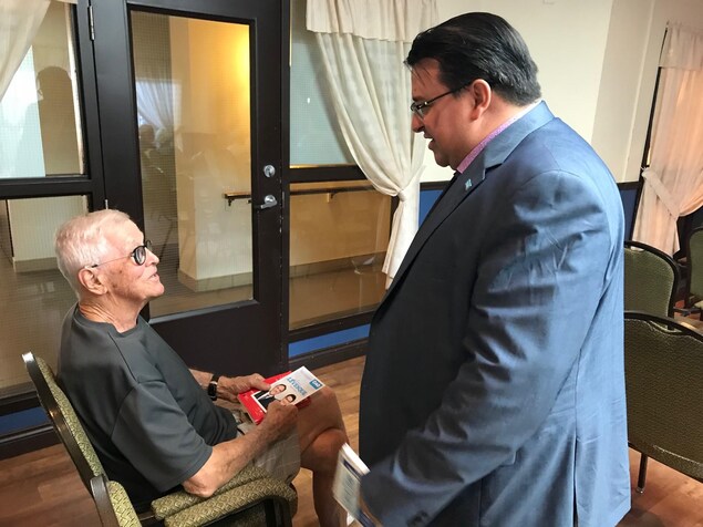 Sylvain Lévesque discute avec un homme âgé. Sylvain Lévesque discute avec un homme âgé.