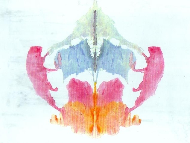 Des taches d'encre coloré (vert pâle, bleu, rose et orange) formant une forme abstraite symétrique. Des taches d'encre coloré (vert pâle, bleu, rose et orange) formant une forme abstraite symétrique.
