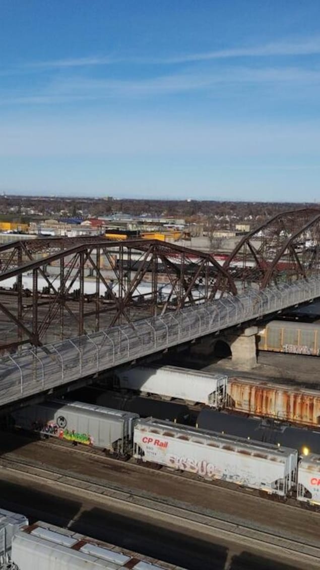 Un pont en acier au-dessus de wagons rouillés à Winnipeg

