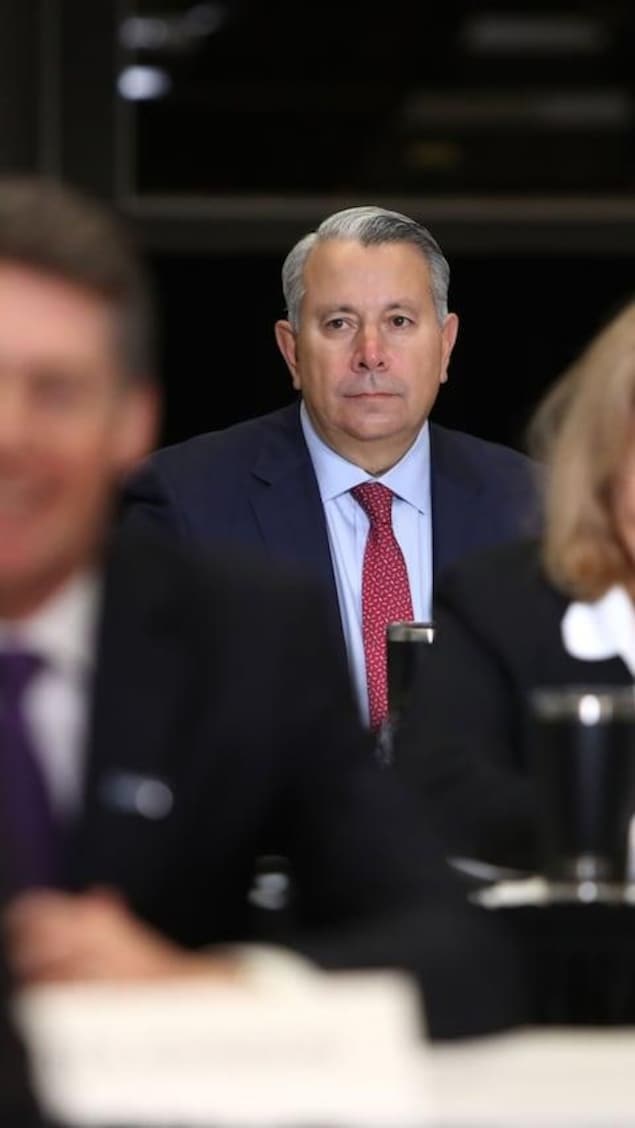 A man in the back of a room in focus.