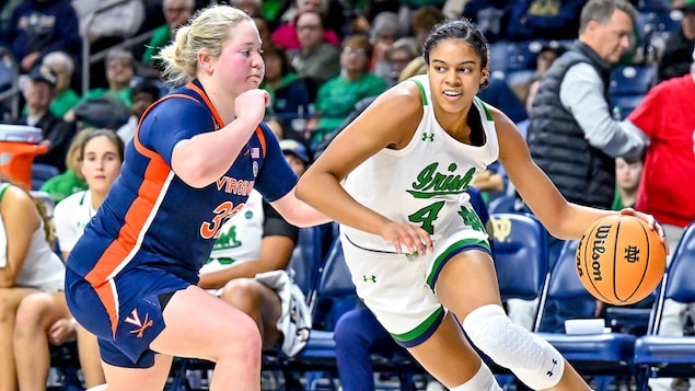 Cassandre Prosper tries to dribble past the University of Virginia Cavaliers guard in a January game at Notre Dame in South Bend, Indiana.
