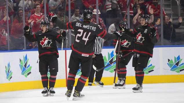 Des hockeyeurs canadiens célèbrent un but.