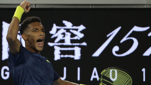 Un joueur de tennis vêtu de bleu et jaune célèbre un point aux Internationaux d'Australie. 