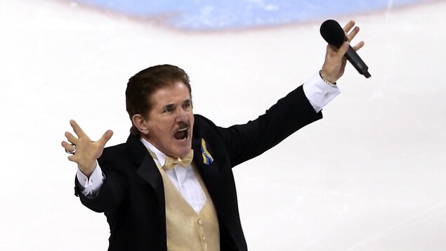 René Rancourt salue la foule après son interprétation de l'hymne national américain lors de la finale de la Coupe Stanley de 2013 entre les Bruins de Boston et les Blackhawks de Chicago. René Rancourt salue la foule après son interprétation de l'hymne national américain lors de la finale de la Coupe Stanley de 2013 entre les Bruins de Boston et les Blackhawks de Chicago.