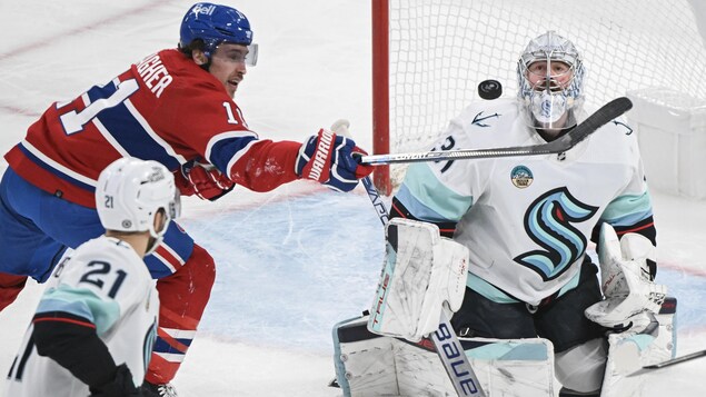 Brendan Gallagher tente de faire dévier une rondelle devant le gardien Philipp Grubauer.