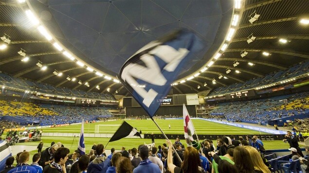 Des partisans agitent des drapeaux.